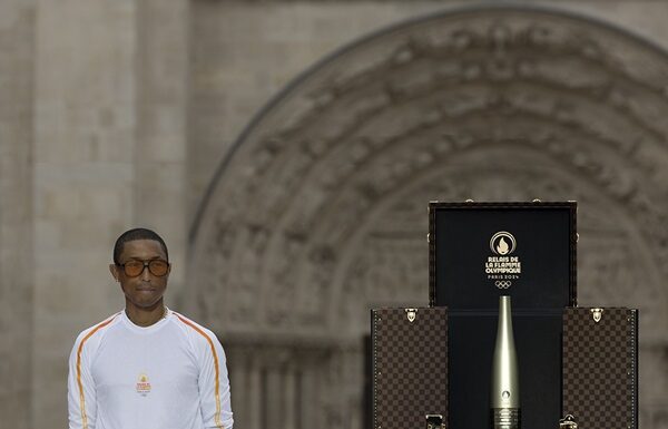 Pharrell Williams Carries Torch at Paris 2024 Olympics Pharrell Williams Carries Torch at Paris 2024 Olympics