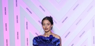 Chase Infiniti wears custom Louis Vuitton to the Opening ceremony during the Series Mania Festival Chase Infiniti wears a long blue satin dress featuring a pleated bustier with 3D detailing and a pair of silver platform.