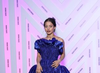 Chase Infiniti wears custom Louis Vuitton to the Opening ceremony during the Series Mania Festival Chase Infiniti wears a long blue satin dress featuring a pleated bustier with 3D detailing and a pair of silver platform.