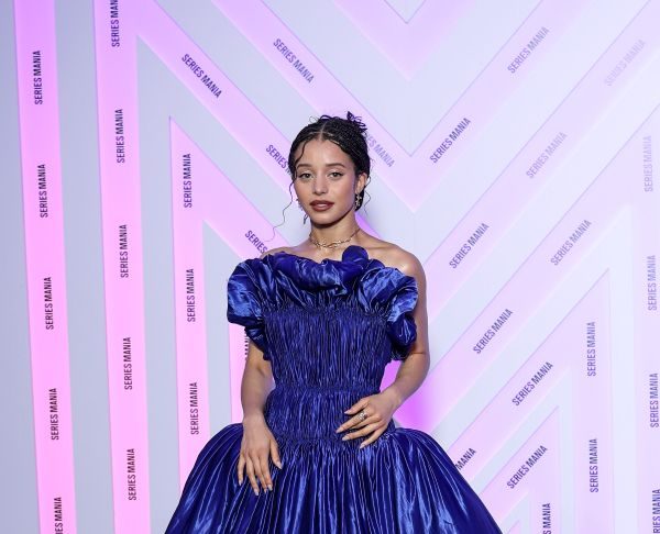 Chase Infiniti wears custom Louis Vuitton to the Opening ceremony during the Series Mania Festival Chase Infiniti wears a long blue satin dress featuring a pleated bustier with 3D detailing and a pair of silver platform.