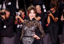Emily Alyn Lind wears Louis Vuitton to the “Company” Screening during the 83rd Venice International Film Festival Emily Alyn Lind wears a black ruffled lace dress with long sleeves and a pair of black satin pumps. Emily Alyn Lind also wears Protection earrings in white, yellow gold and diamonds from the Louis Vuitton Virtuosity collection and a ring in yellow gold, platinum and diamonds from the Louis Vuitton Mythica collection, Louis Vuitton High Jewelry